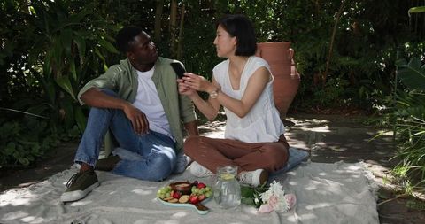 Couple Enjoying Picnic in Garden Leisure Setting