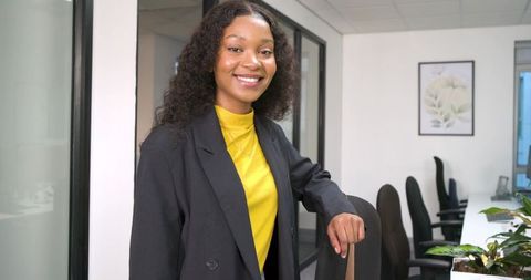 Young Professional Woman Standing in Modern Conference Room