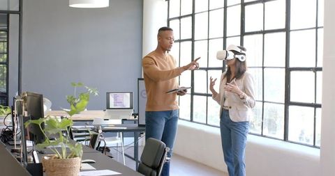 Colleagues Collaborating with Virtual Reality in Modern Office