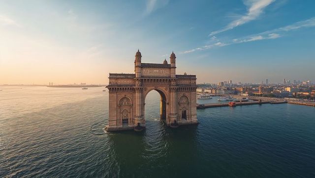 Golden sunrise gateway of india arch overlooking mumbai harbor with ferries and skyline
