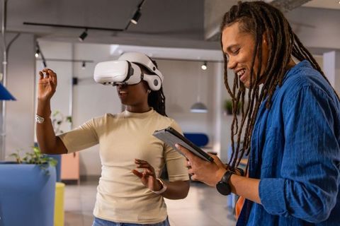African american coworkers testing virtual reality together in modern open-plan office
