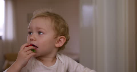 Smiling Toddler Enjoying Strawberry Bliss at Home