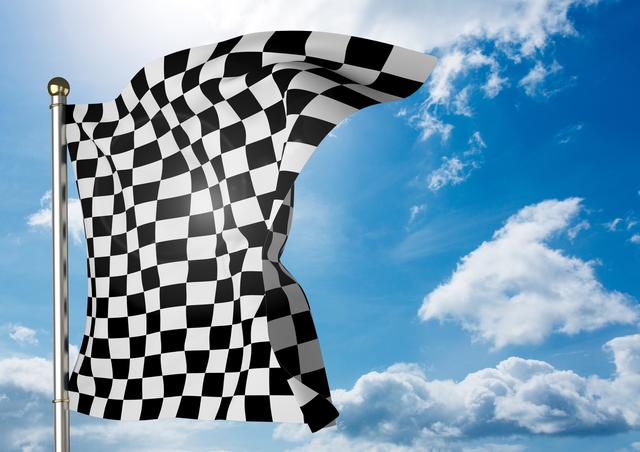Checker flag flapping against sky on a sunny day