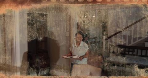 Senior chinese woman holding tray in vintage home interior with warm nostalgic grain