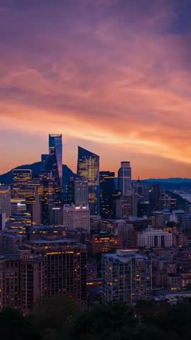 Sunset deepening over vertical city skyline showing glass skyscrapers glowing at twilight
