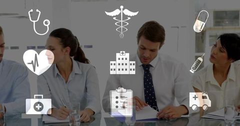 Healthcare team reviewing medical documents in boardroom with digital icons overlay