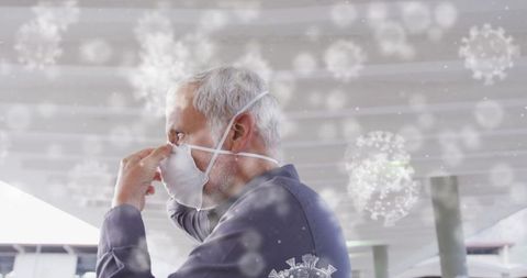 Man adjusting n95 mask at train station with virus graphics