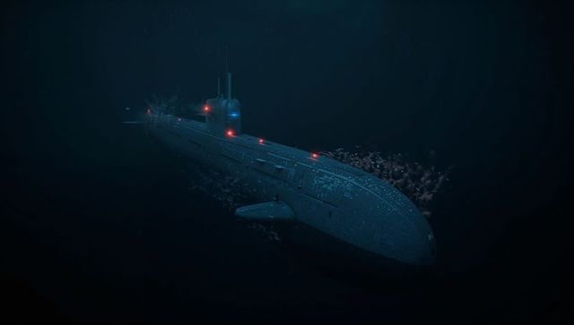 Military submarine gliding through deep ocean with red navigation lights trailing fish