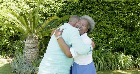 Senior Couple Rejoicing Engagement in Lush Green Garden Setting