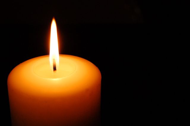 Candle emitting warm light in dark background can be used for themes of tranquility, meditation, and relaxation. Nice for wellness content, spiritual reflections, or creating a calm atmosphere in ads for wellness products.