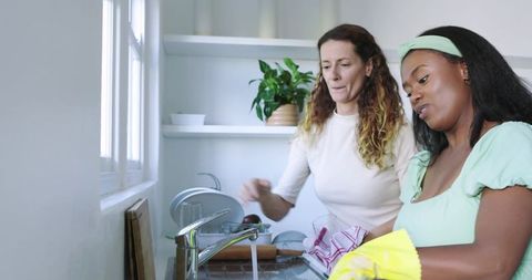Diverse Female Friends Collaborating on Kitchen Chores