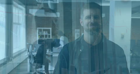 Businessman Smiling with Financial Data Projections in Modern Office