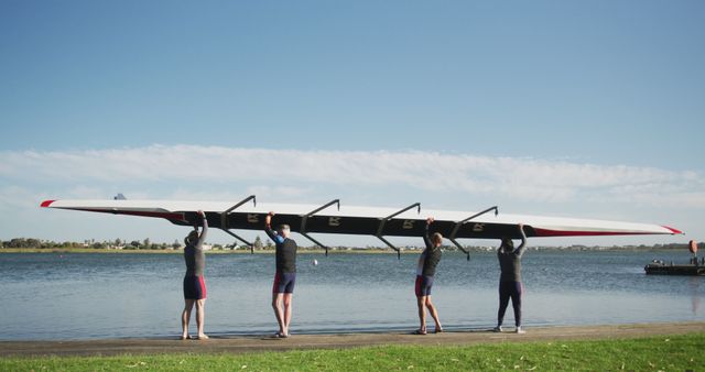 Rowing Team Lifting Boat Near River Shore Under Sunny Sky - Download Free Stock Images Pikwizard.com