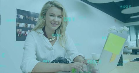 Female photographer working at modern coworking space