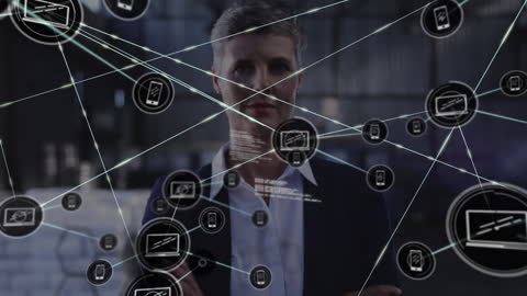 Businesswoman Analyzing Network Data in Warehouse Environment