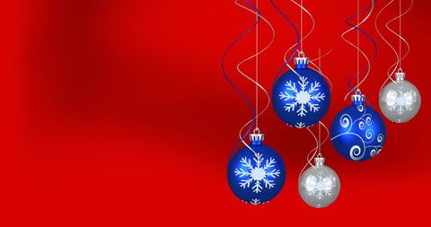 Blue and Silver Christmas Baubles on Red Background