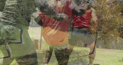 Friends Enjoying Football Game on Park Lawn