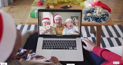 Family video call celebrating christmas with santa hats and holiday decorations