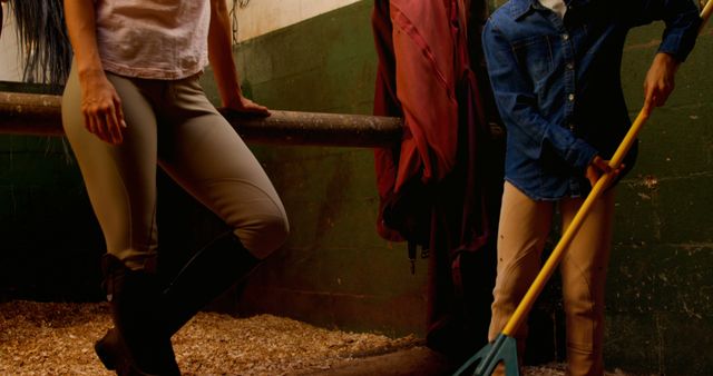 Two People Cleaning Horse Stable in the Evening - Download Free Stock Images Pikwizard.com