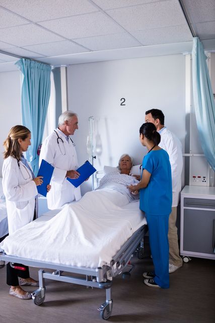 Medical Team Consulting Senior Patient in Hospital Room - Download Free Stock Images Pikwizard.com