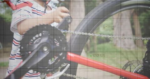 Child Adjusting Red Bicycle Gear in Sunny Park