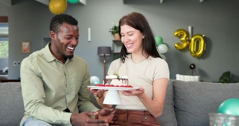 Happy Couple Celebrating Birthday with Cake at Home