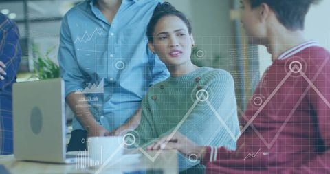 Business Team Analyzing Financial Data with Digital Graphs in Office