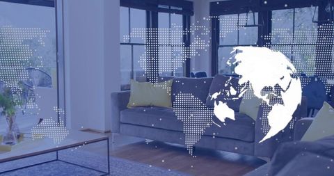 Modern living room projecting digital globe overlay over gray sofa with yellow pillows