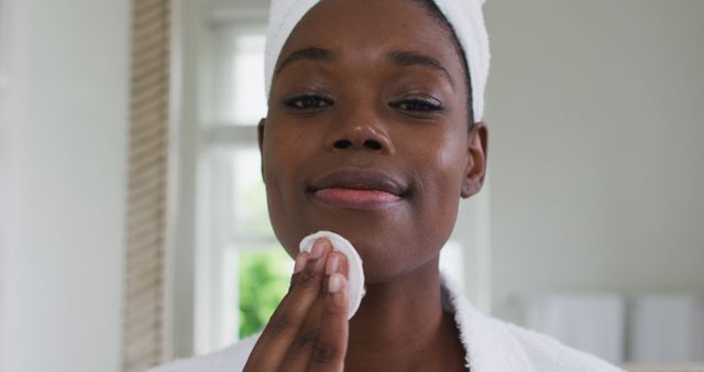 African American woman practices skincare with a cotton pad during quarantine at home. - Download Free Stock Photos Pikwizard.com
