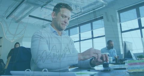 Caucasian Businessman Analyzing Financial Data with Transparent Graphs