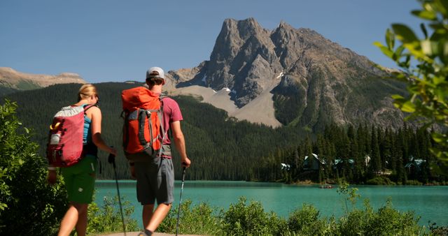 Adventurous Hikers Enjoying Majestic Mountain View Beside Pristine Lake - Download Free Stock Images Pikwizard.com