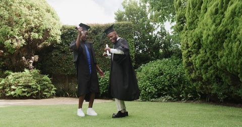 Graduates celebrating achievement in garden setting