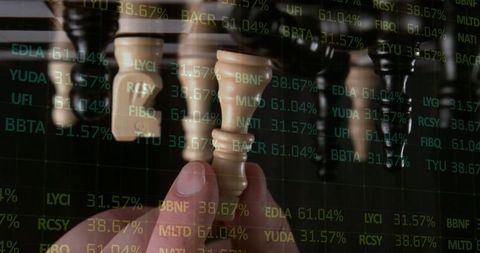 Hand picking chess piece against financial ticker background