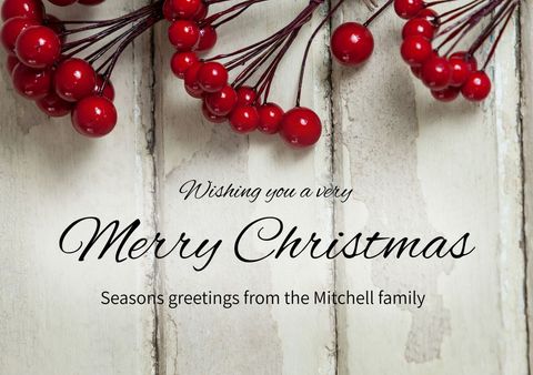 Rustic christmas greeting with red berries and white wood background