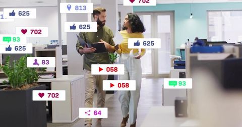Marketing team walking and discussing social media engagement metrics in modern office