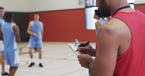 Male Basketball Coach Training Team on Indoor Court