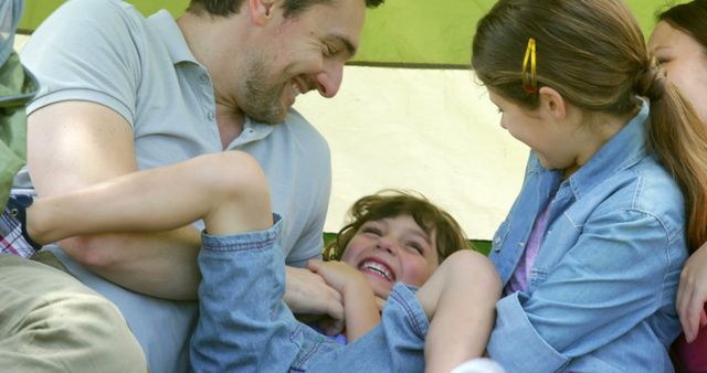 Joyful Family Bonding Outdoors with Playful Laughter - Download Free Stock Images Pikwizard.com