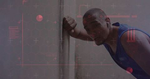 Athlete leaning on concrete column resting between sets with red hud overlay and earbuds