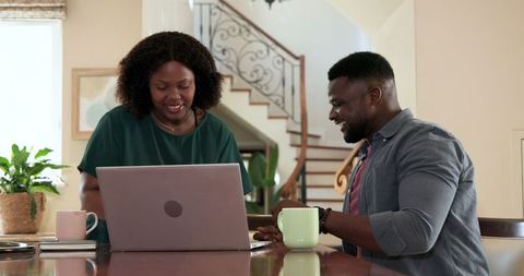Successful Couple Exploring Achievement at Home with Excitement