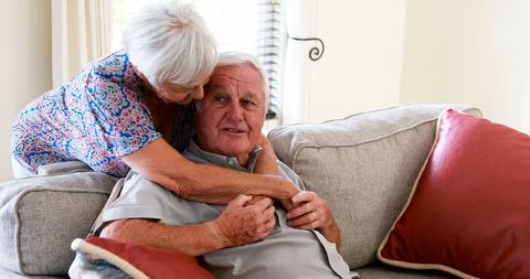 Senior Couple Embracing on Comfortable Living Room Sofa - Download Free Stock Images Pikwizard.com