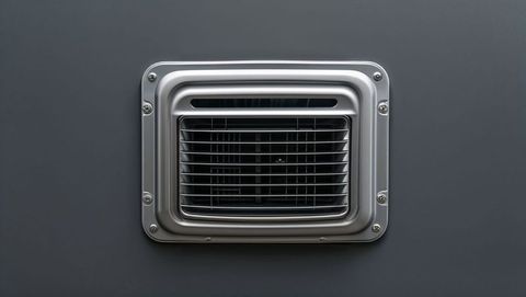 Industrial silver air vent on dark gray panel