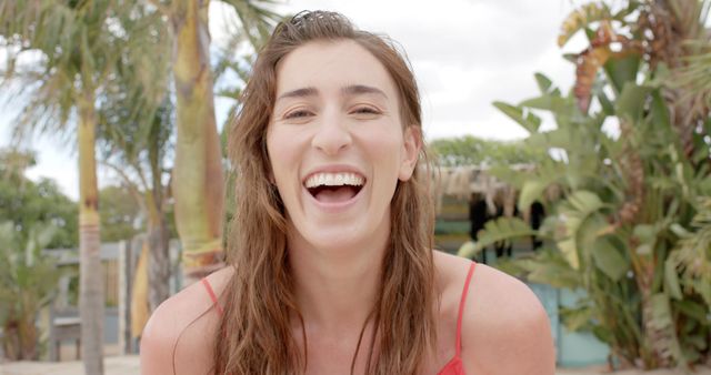 Young Woman Laughing Outdoors in Tropical Setting - Download Free Stock Images Pikwizard.com