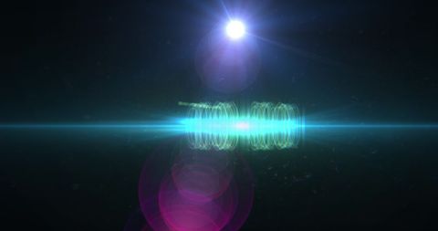 Abstract purple and green lens flare on black background