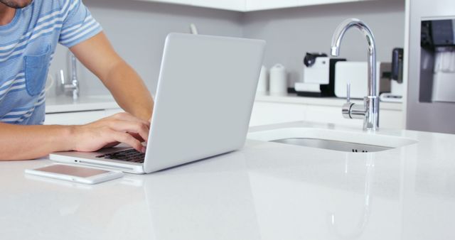 Person Using Laptop in Modern Kitchen - Download Free Stock Images Pikwizard.com