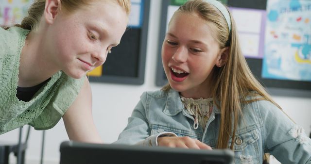 Smiling Schoolgirls Using Tablet in Classroom - Download Free Stock Images Pikwizard.com