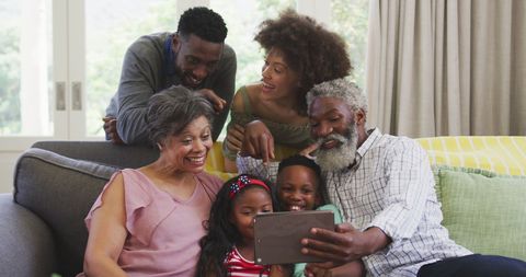Multi-Generational Family Enjoying Time with Tablet