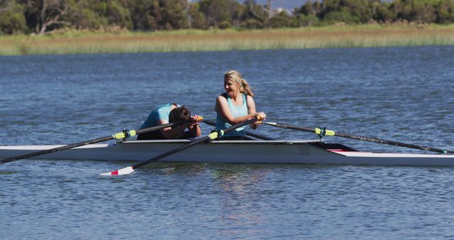 Two senior caucasian women in rowing boat resting. sport retirement leisure hobbies rowing healthy outdoor lifestyle.