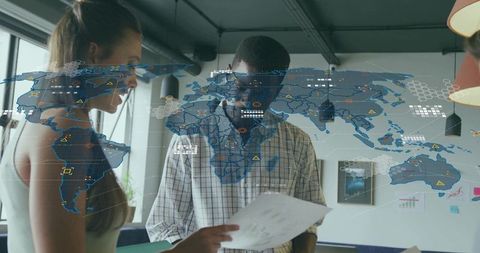 Business Team Collaborating with Holographic World Map