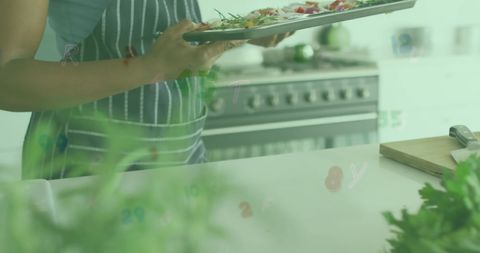 Chef Holding Platter in Educational Kitchen Setting