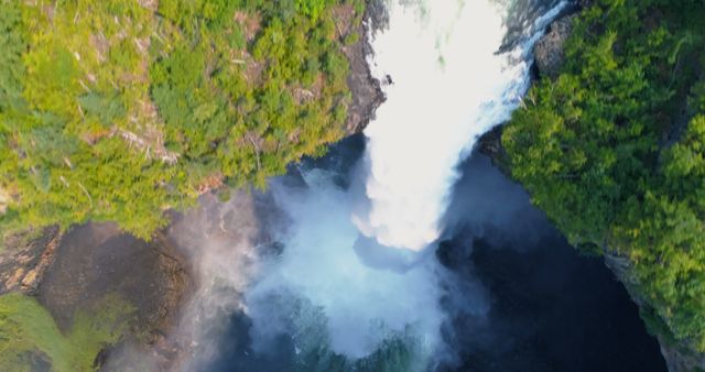 Aerial View of Powerful Waterfall Cascading into Misty Pool Surrounded by Lush Greenery - Download Free Stock Images Pikwizard.com